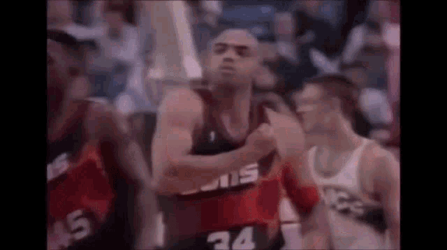 a group of basketball players are playing a game of basketball in a stadium .