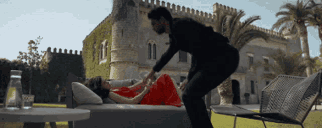 a man standing next to a woman in a red dress