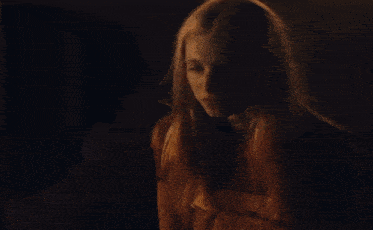 a woman says " you know what i think i think " to a man in a dark room