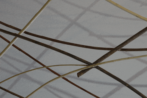 a bunch of sticks hanging from a ceiling