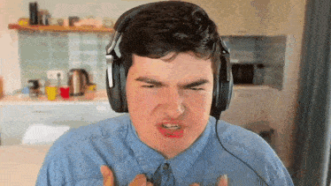 a man wearing headphones is making a funny face
