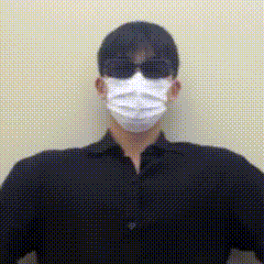 a man wearing a black shirt and a white mask and sunglasses .