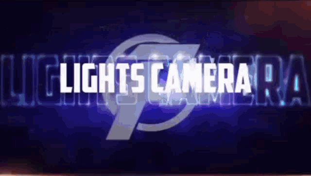 a sign that says lights camera on a dark background