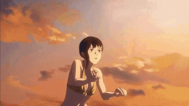 a girl in a bikini is running on a beach .