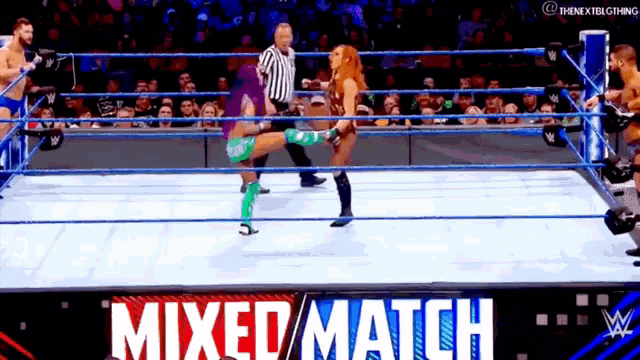 two women are wrestling in a mixed match match