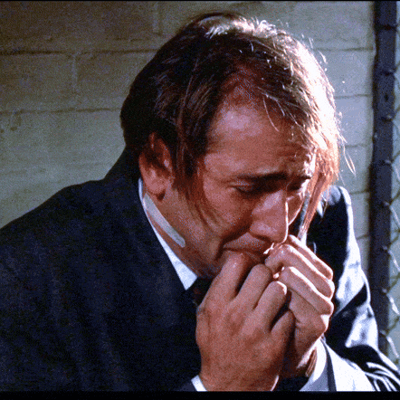 a man in a suit has a bandage on his mouth