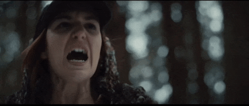 a close up of a woman with her mouth open