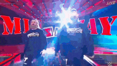 a man in a wrestler 's sweatshirt is walking through a tunnel .
