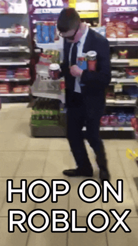 a man in a suit is standing in front of a costa coffee display