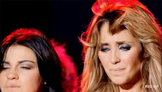two women are standing next to each other with rbd.gif written in the corner