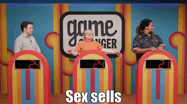 three people playing a game called game changer with the word sex sells in the corner