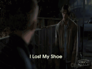 a man in a black jacket says " i lost my shoe " in front of a divx logo