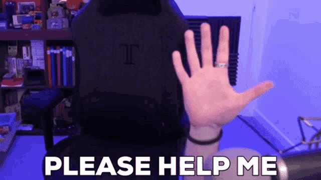 a person is waving their hand in front of a sign that says " please help me "