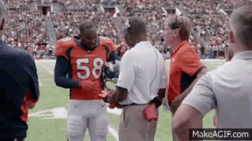 a football player with the number 58 on his jersey is talking to his coach