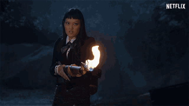 a woman is holding a gun with flames coming out of it and the word netflix is visible in the corner