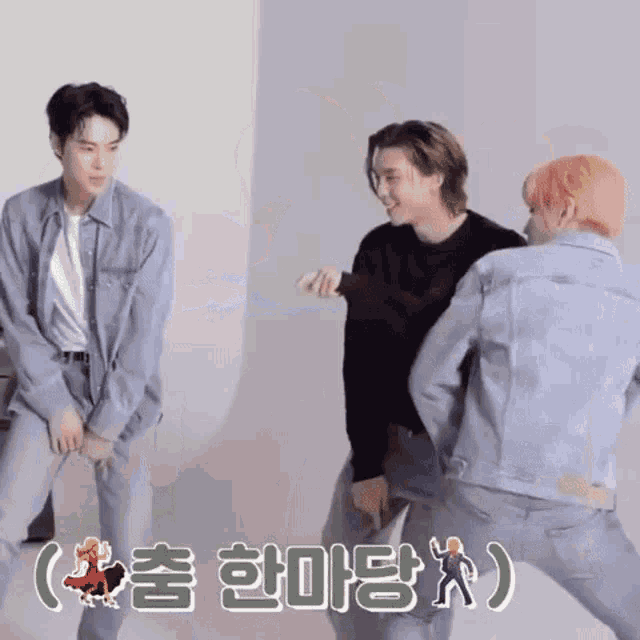 a group of young men are standing next to each other in a room and dancing .