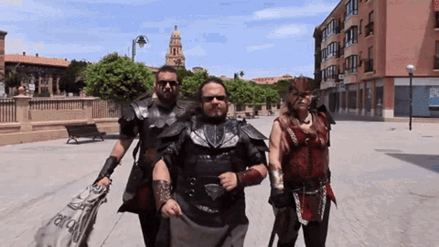 a group of people are walking down a street and one of them is wearing a costume that says ' alianza '