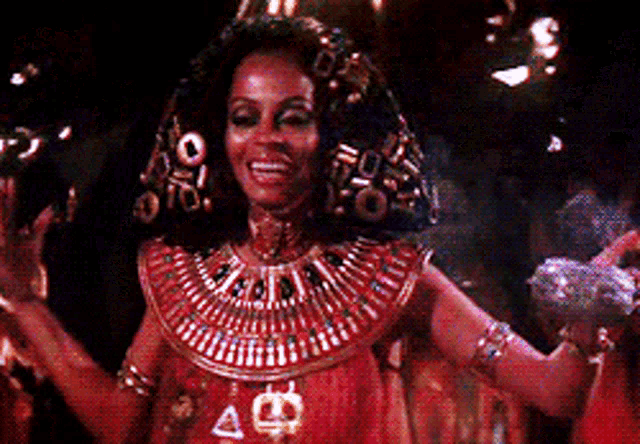 a woman in a costume with a necklace that says a on it
