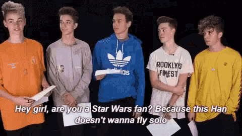 a group of young men are standing next to each other and one of them is wearing a hoodie that says adidas