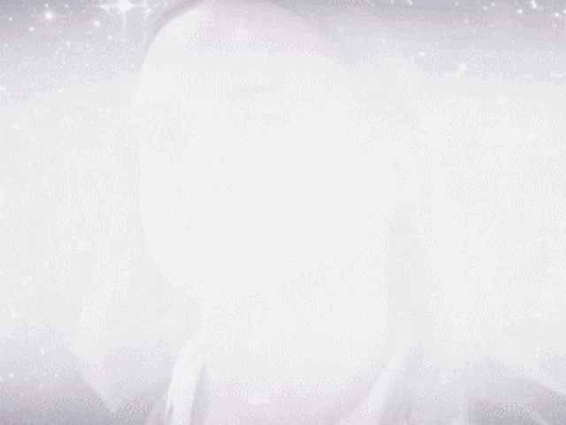 a close up of a woman 's face with a galaxy in the background