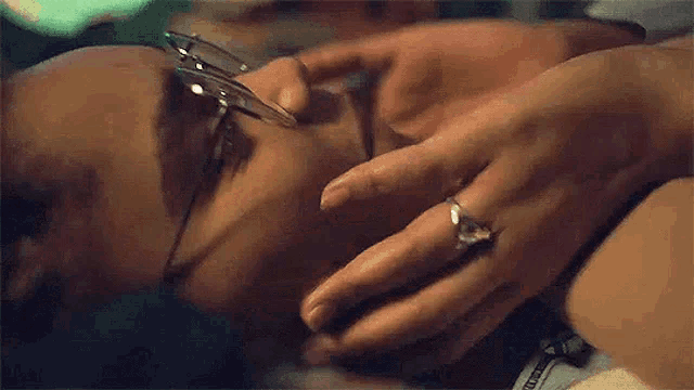 a close up of a person covering another person 's face .