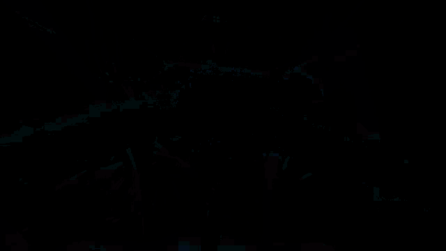 a video game is being played in a dark room with fireworks in the background .