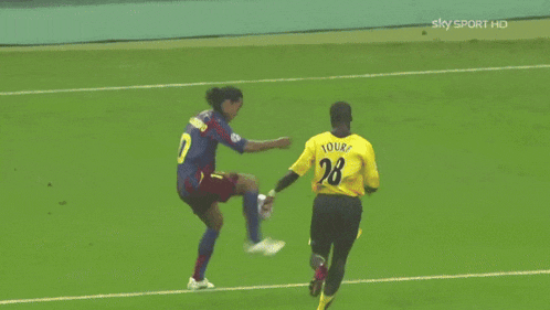 a soccer player with the number 28 on his back kicks the ball