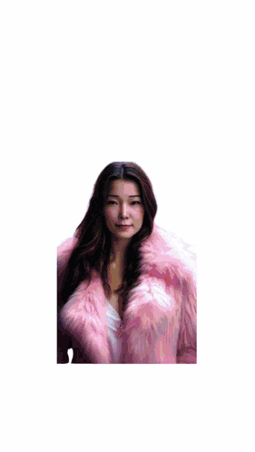 a woman in a pink fur coat is standing in front of a star maker sign