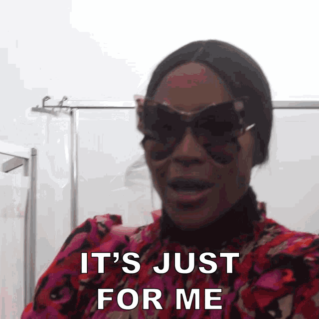 a woman wearing sunglasses and a floral dress says it 's just for me