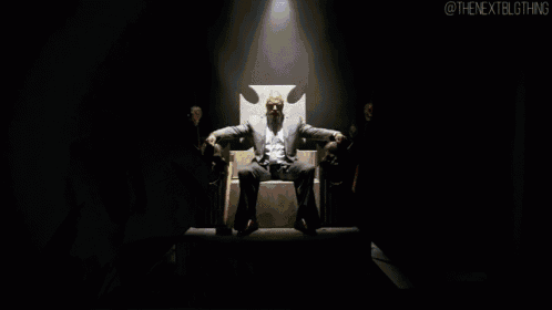 a man sitting on a throne with the nextblgthing written on the bottom right