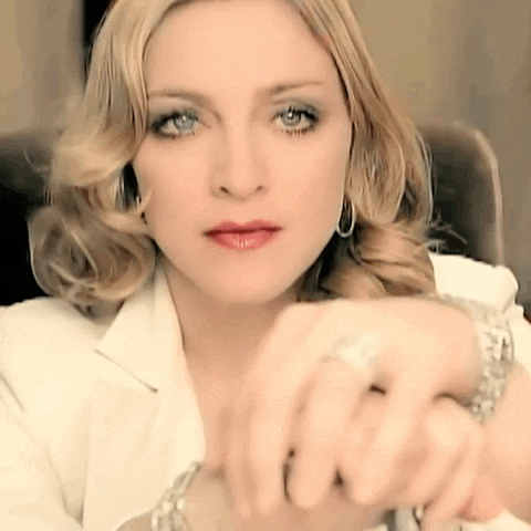 a close up of a woman wearing a watch and a ring on her finger
