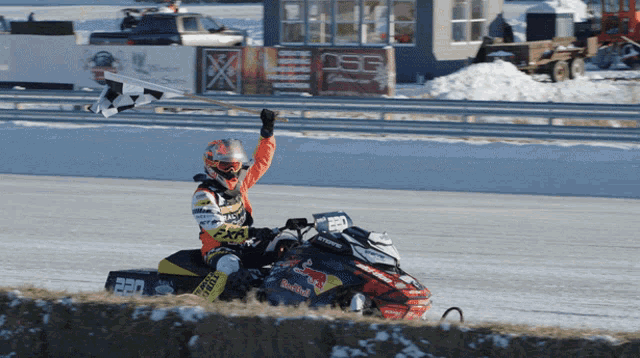 a man riding a snowmobile with the number 520 on the front