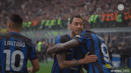 a soccer player with the number 10 on his shirt is hugging another player