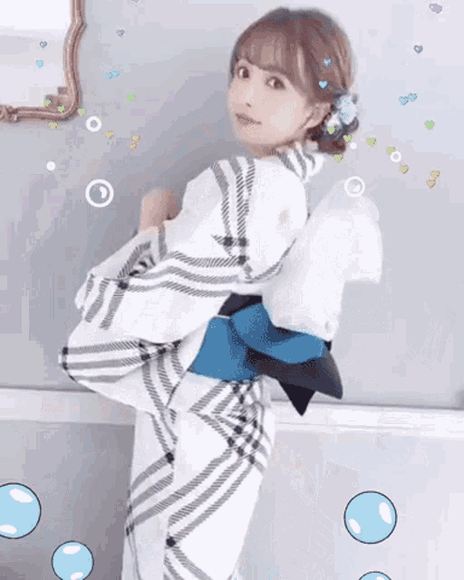 a woman in a white and black kimono is standing in front of a mirror surrounded by bubbles .