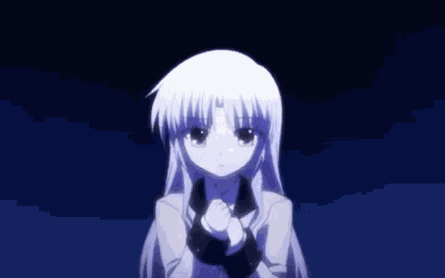 a girl with long white hair is standing in the dark with her hands folded in front of her face .