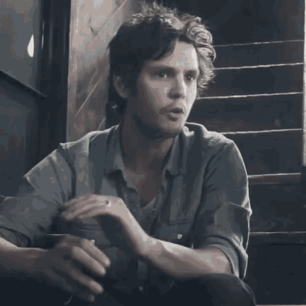 a man is sitting on a set of stairs with the word wussy written on the bottom