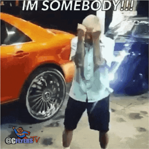a man is dancing in front of an orange car with the caption im somebody !!!