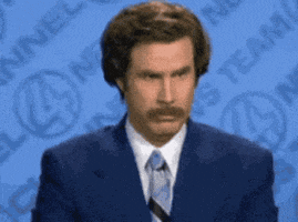 a man in a suit and tie is standing in front of a blue background that says news team