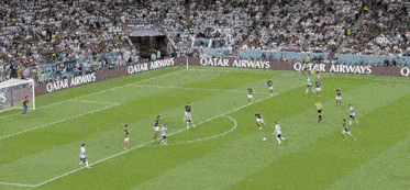 a soccer game is being played on a field that has qatar energy written on the sidelines