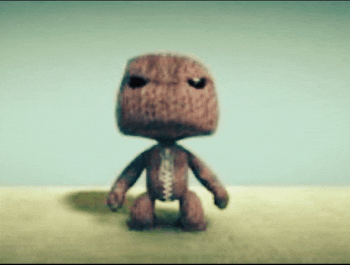 a stuffed animal with a zipper on its chest is standing on a table
