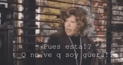 a woman is standing in front of a window with the words " pues esta " written on it