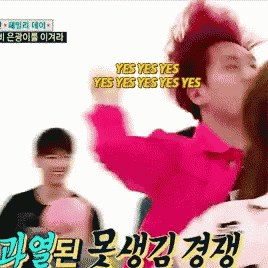 a man in a pink shirt is saying yes yes yes yes