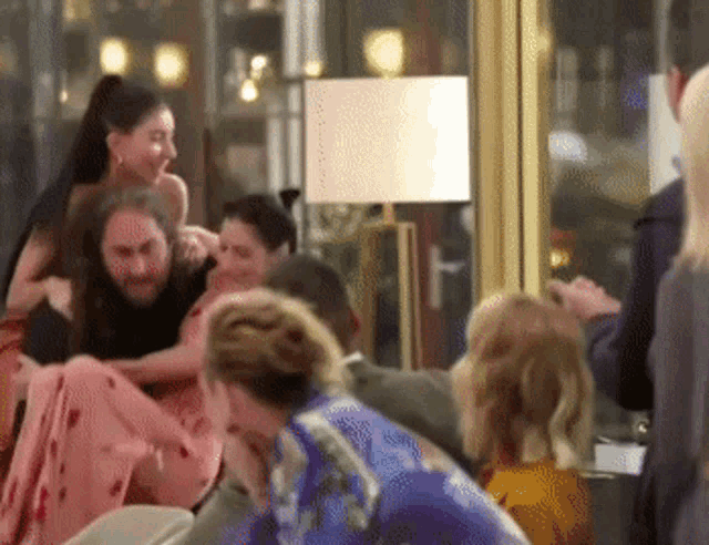 a group of people are having a fight in a room