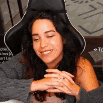 a woman is sitting in a chair with her eyes closed