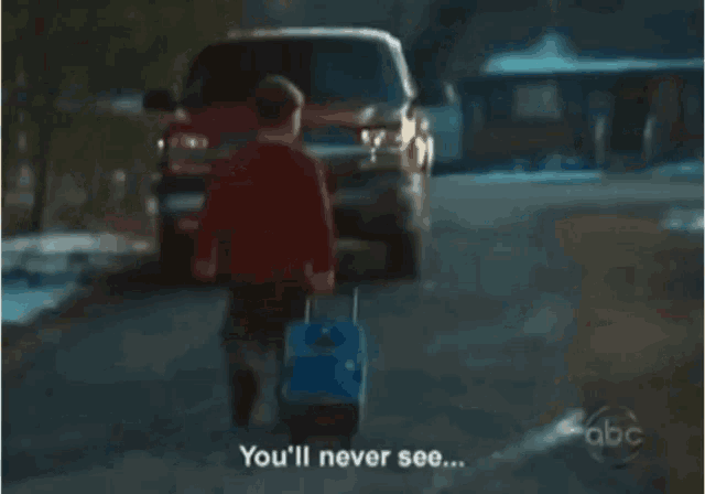 a boy with a suitcase is walking towards a red truck with the words this face again
