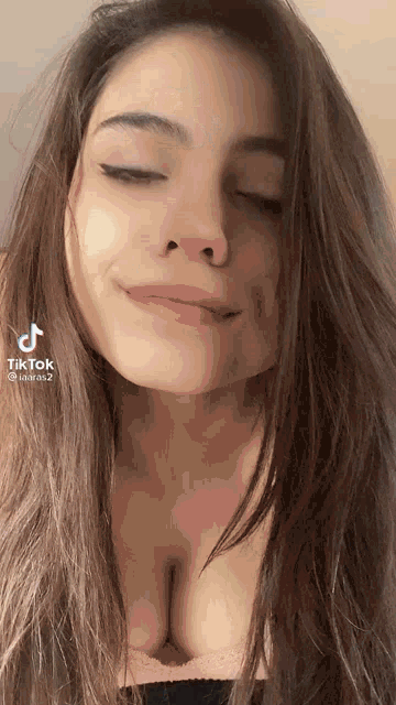 a close up of a woman 's face with her eyes closed