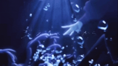a person 's hand is reaching out towards a blue background
