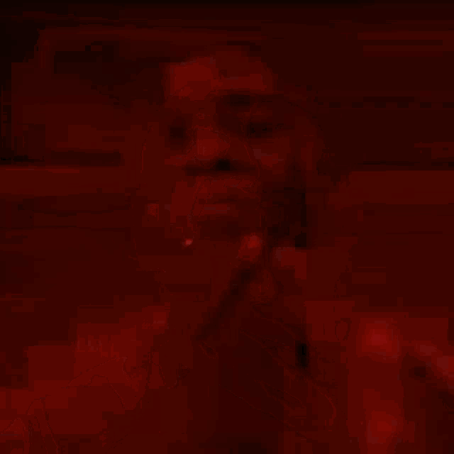 a close up of a man 's face with a red light coming out of his eyes .