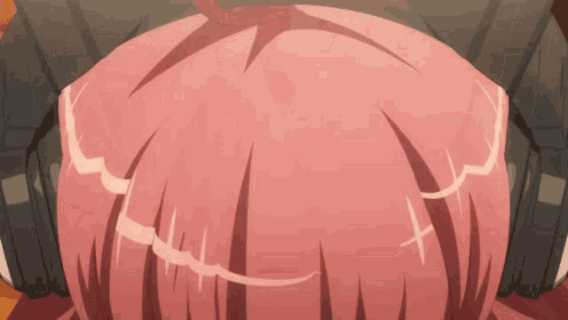 a close up of a person 's head with pink hair and headphones on