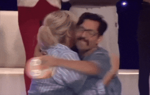 a man and a woman hugging each other with the number 8 on the back
